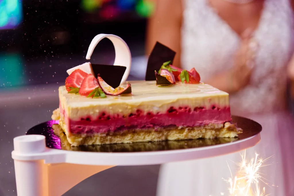 Gâteau de mariage aux fruits rouges et étincelles lors d'une réception à Saint-Hilaire-du-Harcouët en Normandie.