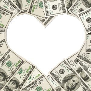 One hundred dollar bills in the shape of a heart isolated on white background The love of money